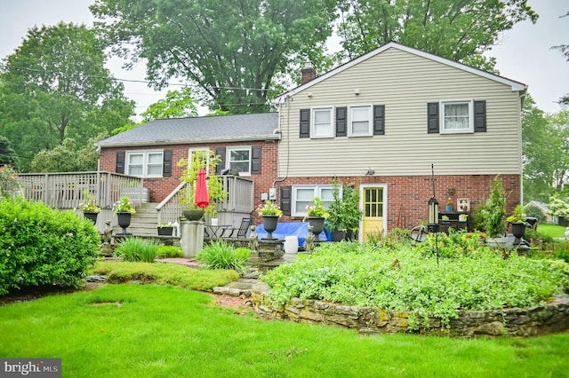 1909 Bloomingdale Ave, Lancaster, PA 17601 - back of house featuring a chimney, brick siding, a lawn, and a deck