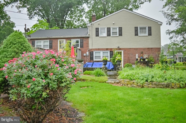1909 Bloomingdale Ave, Lancaster, PA 17601 - tri-level home featuring a chimney, brick siding, and a front lawn