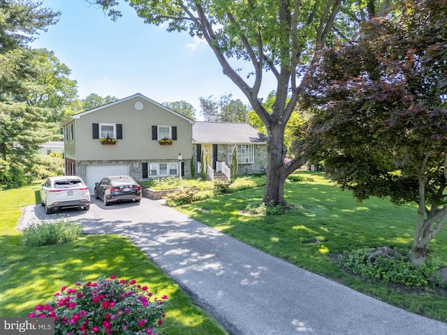 1909 Bloomingdale Ave, Lancaster, PA 17601 - split level home featuring a garage, asphalt driveway, and a front lawn