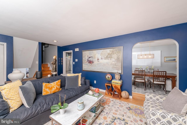 1909 Bloomingdale Ave, Lancaster, PA 17601 - living area featuring wood finished floors, arched walkways, a chandelier, and baseboards