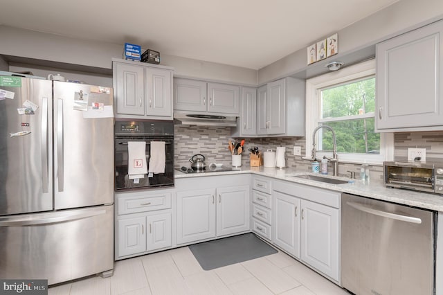 1909 Bloomingdale Ave, Lancaster, PA 17601 - kitchen featuring black appliances, a sink, decorative backsplash, and light stone countertops