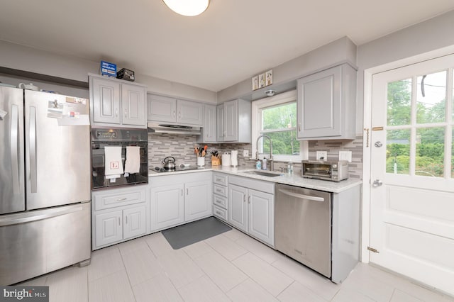 1909 Bloomingdale Ave, Lancaster, PA 17601 - kitchen with black appliances, backsplash, a sink, and light countertops
