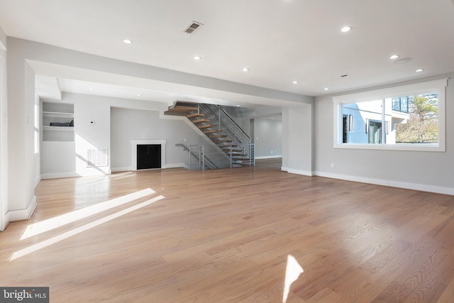 2100 S Pierce St, Arlington, VA 22202 - unfurnished living room featuring stairs, a fireplace, baseboards, light wood-style floors, and recessed lighting