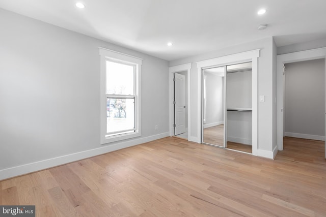 2100 S Pierce St, Arlington, VA 22202 - unfurnished bedroom with baseboards, recessed lighting, light wood-style floors, and a closet