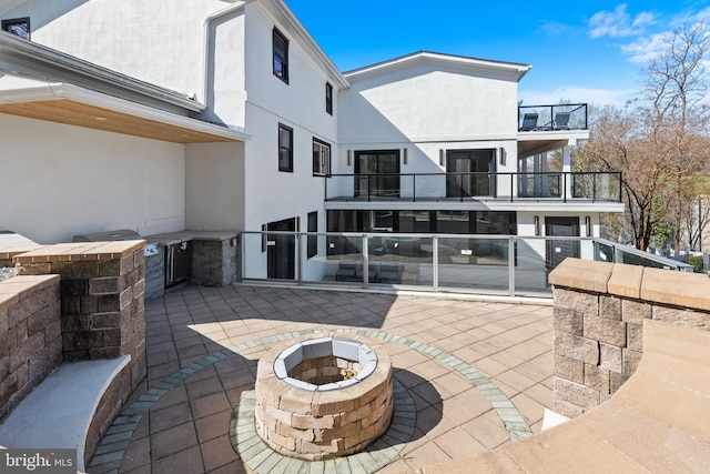 2100 S Pierce St, Arlington, VA 22202 - view of patio featuring an outdoor fire pit, a balcony, and an outdoor kitchen