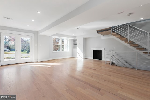 2100 S Pierce St, Arlington, VA 22202 - unfurnished living room featuring light wood-type flooring, baseboards, recessed lighting, a fireplace, and french doors