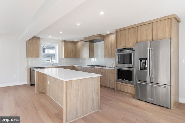 2100 S Pierce St, Arlington, VA 22202 - kitchen with stainless steel appliances, modern cabinets, a kitchen island, light wood finished floors, and decorative backsplash