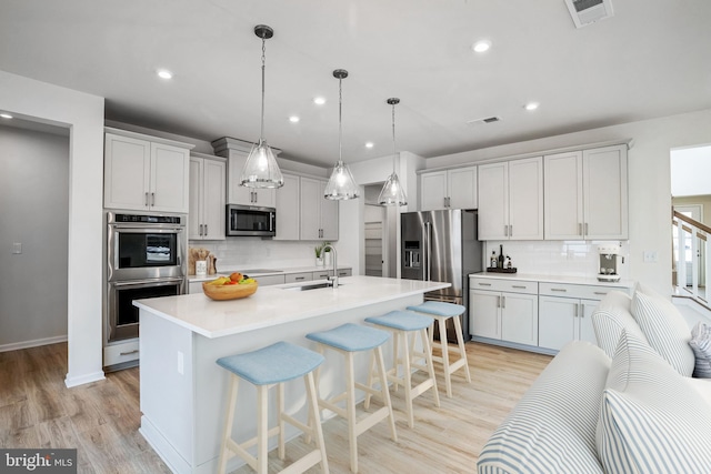 35242 Duck Haven Rd, Selbyville, DE 19975 - kitchen featuring stainless steel appliances, a sink, decorative backsplash, light countertops, and recessed lighting