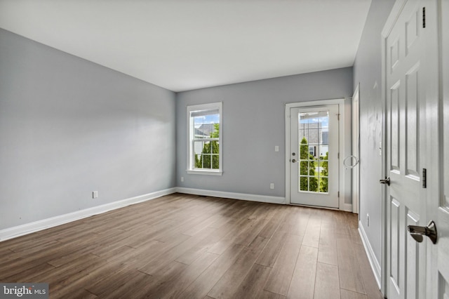 spare room featuring wood finished floors and baseboards