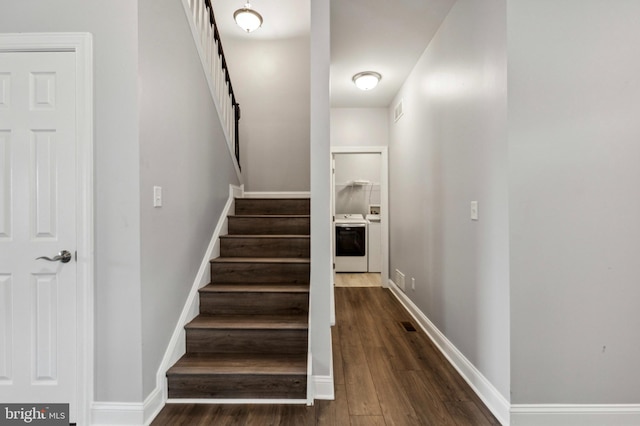 staircase featuring wood finished floors and baseboards