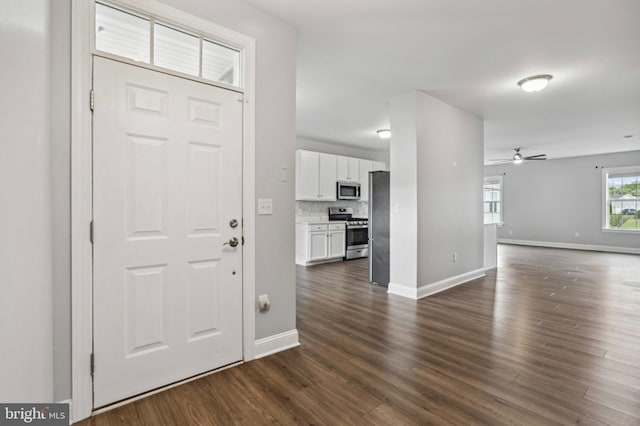 entrance foyer featuring ceiling fan, baseboards, and dark wood-style floors