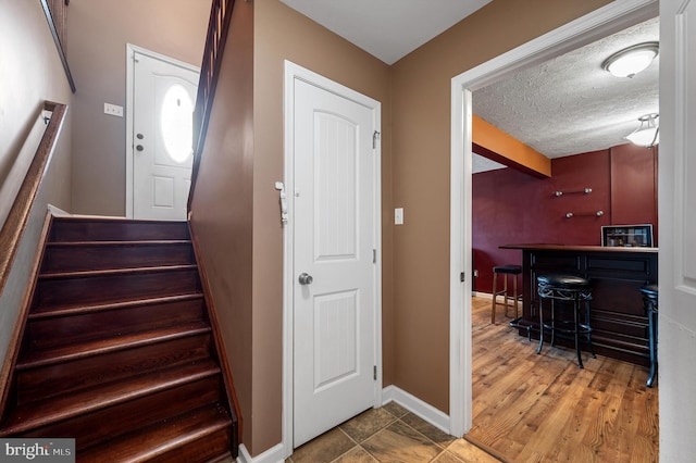 81 Toulouse Ln, Martinsburg, WV 25403 - staircase with a bar, baseboards, and a textured ceiling