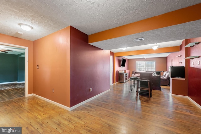 81 Toulouse Ln, Martinsburg, WV 25403 - dining room with a textured ceiling, wood finished floors, and baseboards