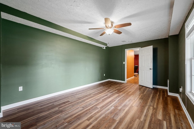 81 Toulouse Ln, Martinsburg, WV 25403 - unfurnished bedroom featuring wood finished floors, baseboards, a textured ceiling, and a ceiling fan