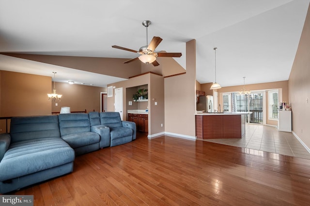 81 Toulouse Ln, Martinsburg, WV 25403 - living area featuring a chandelier, baseboards, ceiling fan, wood finished floors, and high vaulted ceiling