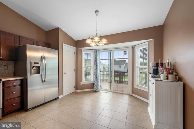 81 Toulouse Ln, Martinsburg, WV 25403 - kitchen featuring stainless steel fridge, lofted ceiling, a chandelier, baseboards, and light countertops