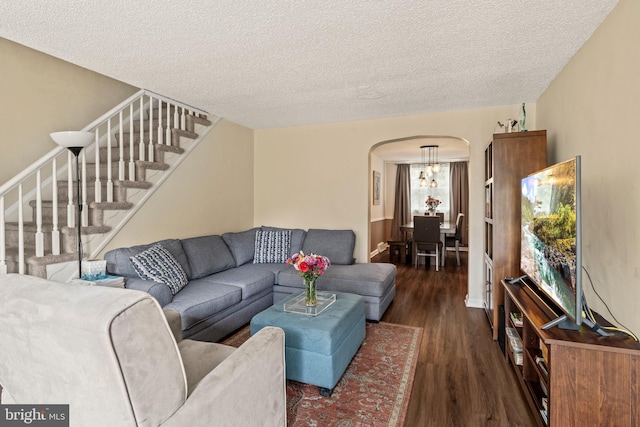 2319 Bond Ave, Drexel Hill, PA 19026 - living area featuring arched walkways, dark wood-style flooring, a textured ceiling, and stairs