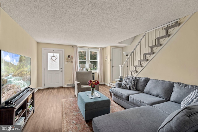 2319 Bond Ave, Drexel Hill, PA 19026 - living room featuring wood finished floors, stairway, and a textured ceiling