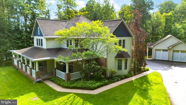 43 Shea Dr, Mohnton, PA 19540 - view of front of property featuring an outdoor structure, roof with shingles, a porch, a front yard, and a garage