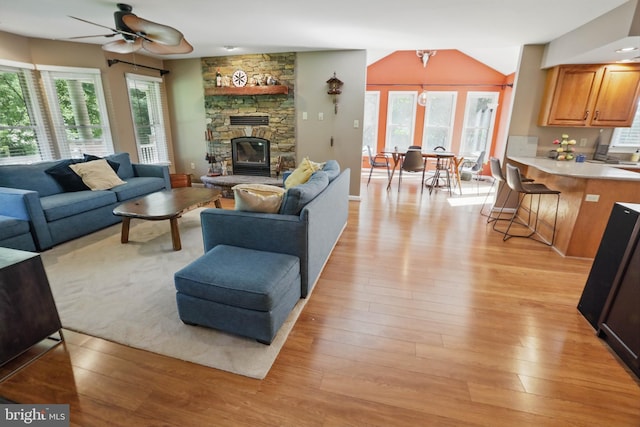 43 Shea Dr, Mohnton, PA 19540 - living area featuring light wood-type flooring, healthy amount of natural light, a stone fireplace, and a ceiling fan