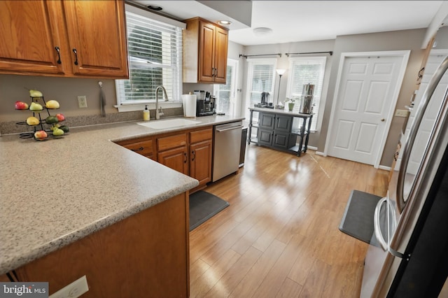 43 Shea Dr, Mohnton, PA 19540 - kitchen with stainless steel appliances, a sink, brown cabinetry, and light wood finished floors
