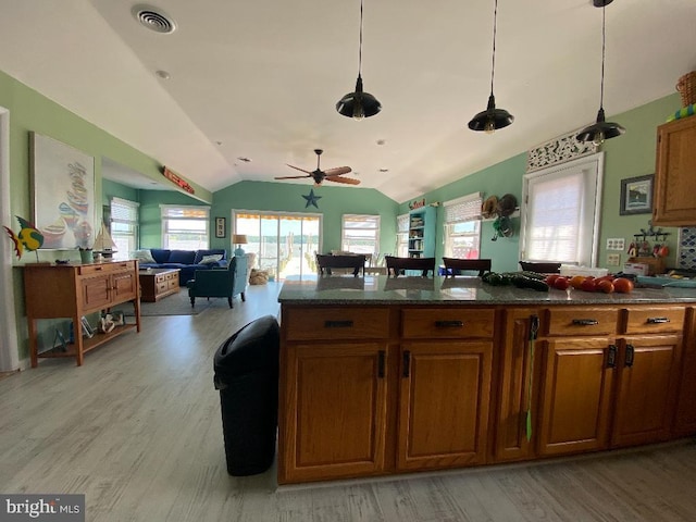 53 Pleasure Shores Cir, Chesapeake City, MD 21915 - kitchen featuring light wood-type flooring, lofted ceiling, plenty of natural light, and brown cabinetry