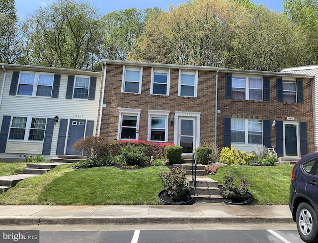 12415 Morning Light Ter, Gaithersburg, MD 20878 - view of property featuring uncovered parking, a front yard, and brick siding
