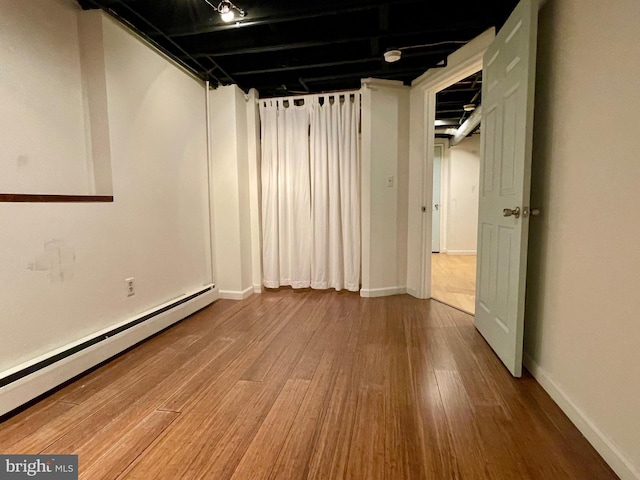 2732 Maryland Ave, Baltimore, MD 21218 - finished basement featuring baseboard heating, wood finished floors, and baseboards