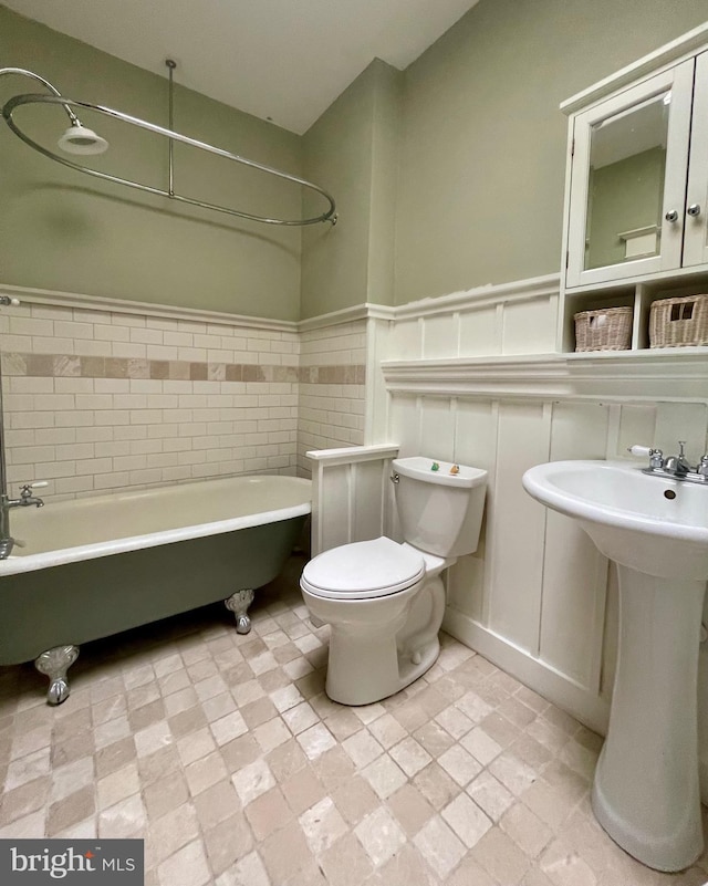 2732 Maryland Ave, Baltimore, MD 21218 - full bathroom with a freestanding bath, toilet, wainscoting, and a sink
