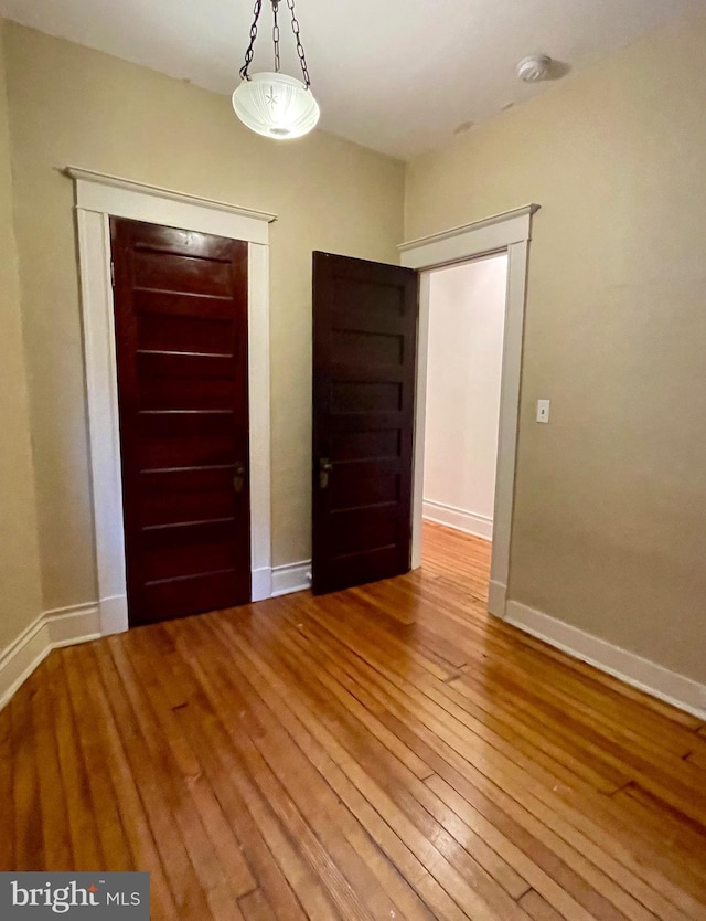 2732 Maryland Ave, Baltimore, MD 21218 - spare room featuring wood-type flooring, baseboards, and a smoke detector