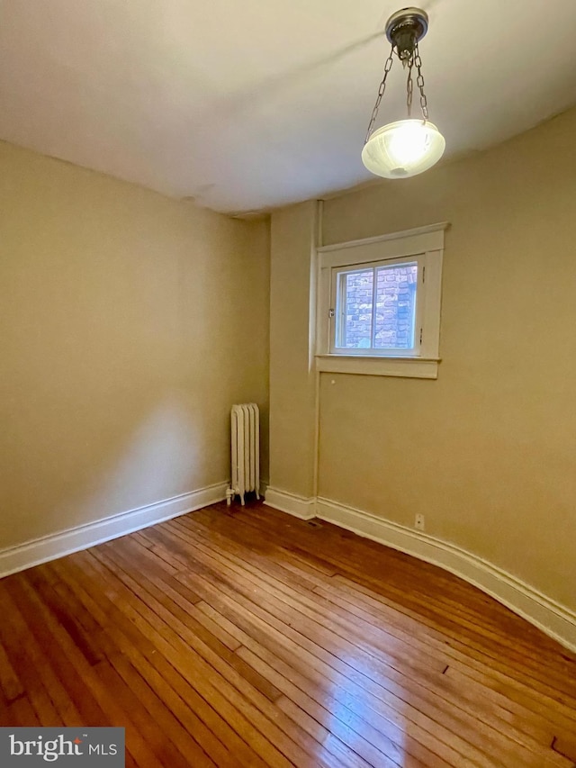 2732 Maryland Ave, Baltimore, MD 21218 - empty room featuring radiator heating unit, hardwood / wood-style flooring, and baseboards