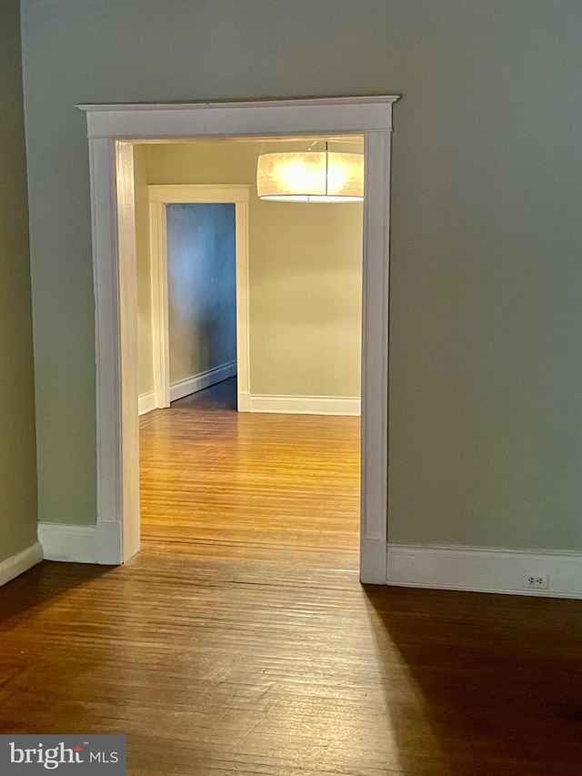2732 Maryland Ave, Baltimore, MD 21218 - corridor with wood finished floors, baseboards, and a baseboard heating unit