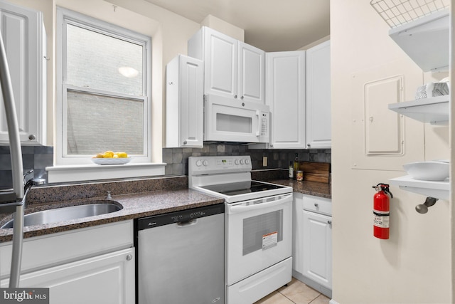 1742 U St NW Unit 101, Washington, DC 20009 - kitchen with white appliances, a sink, white cabinets, and light tile patterned floors