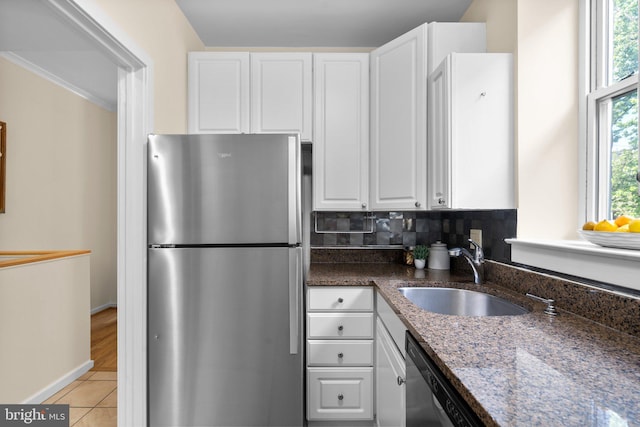 1742 U St NW Unit 101, Washington, DC 20009 - kitchen with stainless steel appliances, a sink, white cabinets, dark stone counters, and light tile patterned floors