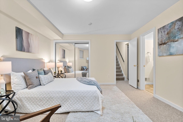 1742 U St NW Unit 101, Washington, DC 20009 - bedroom with baseboards, carpet flooring, a closet, and ensuite bath