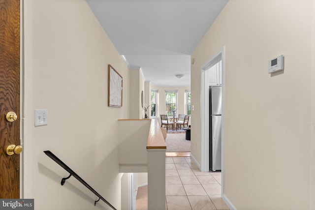 1742 U St NW Unit 101, Washington, DC 20009 - hallway with an upstairs landing, light tile patterned floors, and baseboards