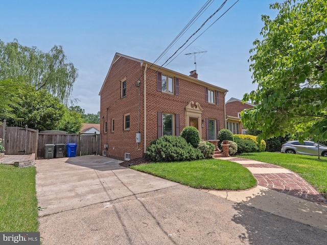 11 S Hudson St, Arlington, VA 22204 - colonial house featuring brick siding, concrete driveway, and a chimney