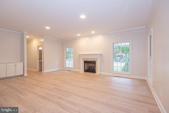 101 Port Arthur Ct, Ocean Pines, MD 21811 - unfurnished living room featuring crown molding, healthy amount of natural light, light wood-style flooring, a fireplace, and recessed lighting