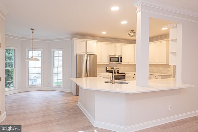 101 Port Arthur Ct, Ocean Pines, MD 21811 - kitchen with stainless steel appliances, light wood-style flooring, backsplash, baseboards, and ornamental molding
