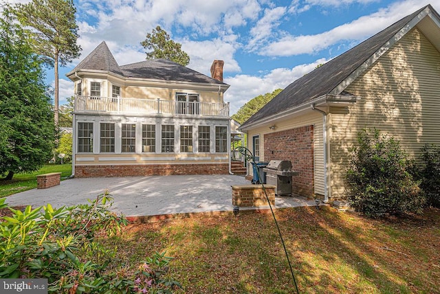 101 Port Arthur Ct, Ocean Pines, MD 21811 - rear view of house with a balcony, a patio, a chimney, and an attached garage