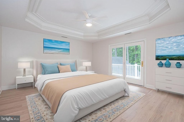 101 Port Arthur Ct, Ocean Pines, MD 21811 - bedroom with ornamental molding, access to exterior, light wood-type flooring, a tray ceiling, and baseboards