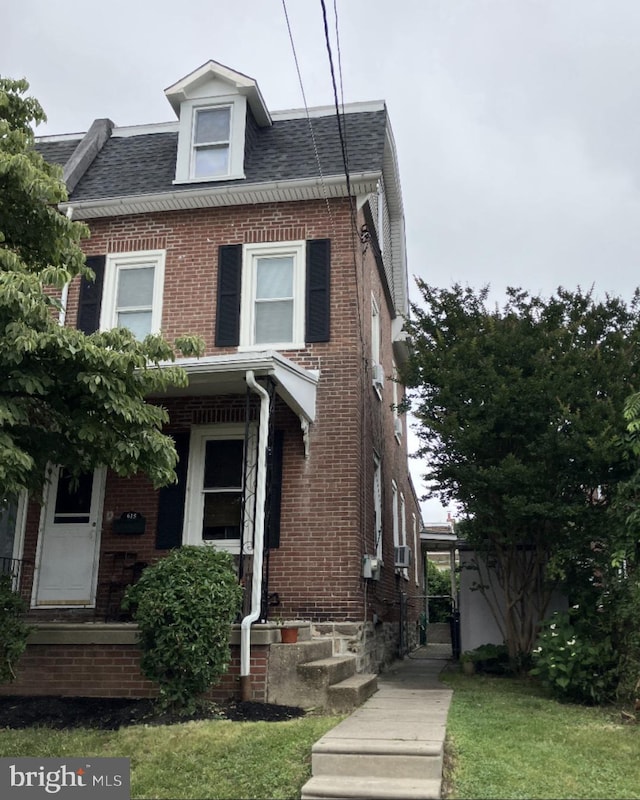615 Hoffnagle St, Philadelphia, PA 19111 - view of property featuring brick siding, a shingled roof, and a front yard