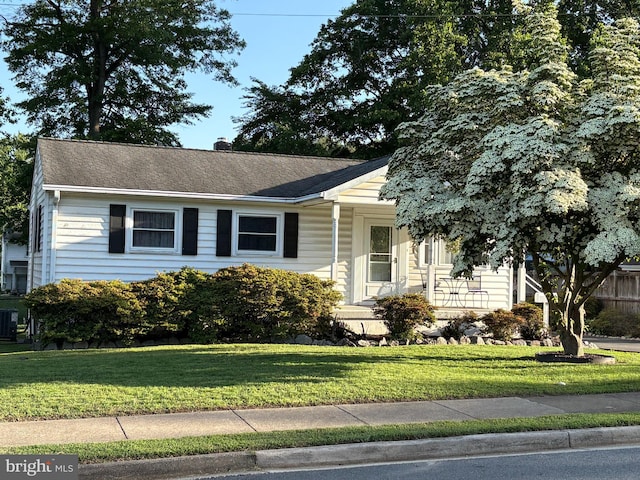 1421 Maryland Ave, Woodbridge, VA 22191 - view of front facade with a front lawn, a chimney, central AC unit, and roof with shingles