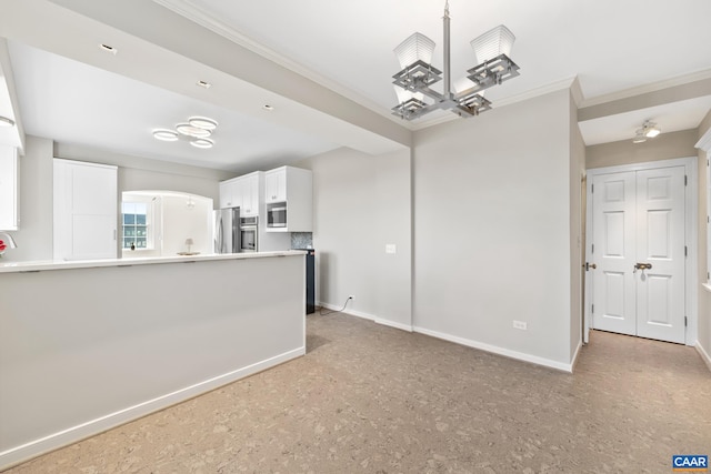500 Court Sq Unit 503And 504, Charlottesville, VA 22902 - kitchen featuring appliances with stainless steel finishes, ornamental molding, white cabinets, baseboards, and a peninsula
