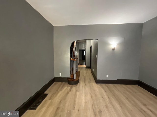 1204 Carl Miller Blvd, Camden, NJ 08104 - spare room featuring arched walkways, wood finished floors, and baseboards