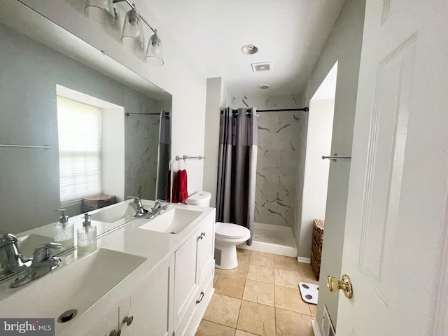 full bath featuring a stall shower, toilet, double vanity, and tile patterned flooring