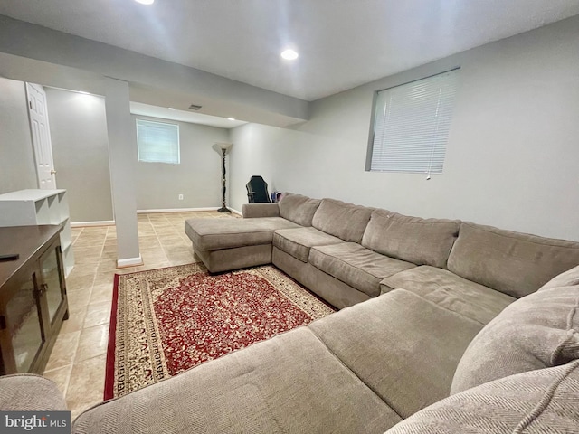 living area with recessed lighting and light tile patterned flooring