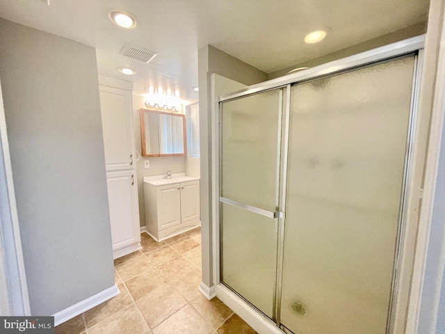 bathroom featuring a shower stall, vanity, baseboards, and recessed lighting