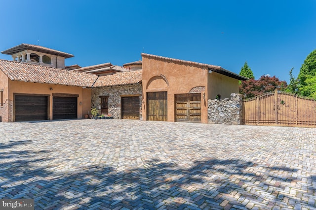 13320 Signal Tree, Potomac, MD 20854 - mediterranean / spanish-style house featuring a gate, a tile roof, stucco siding, and driveway
