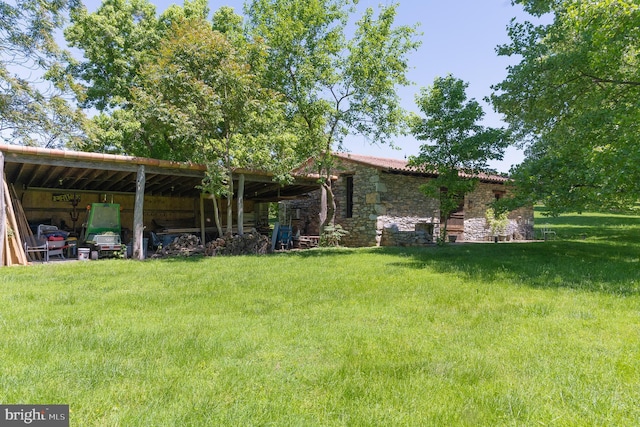 13320 Signal Tree, Potomac, MD 20854 - view of front facade with a pole building, stone siding, a front lawn, and an outbuilding